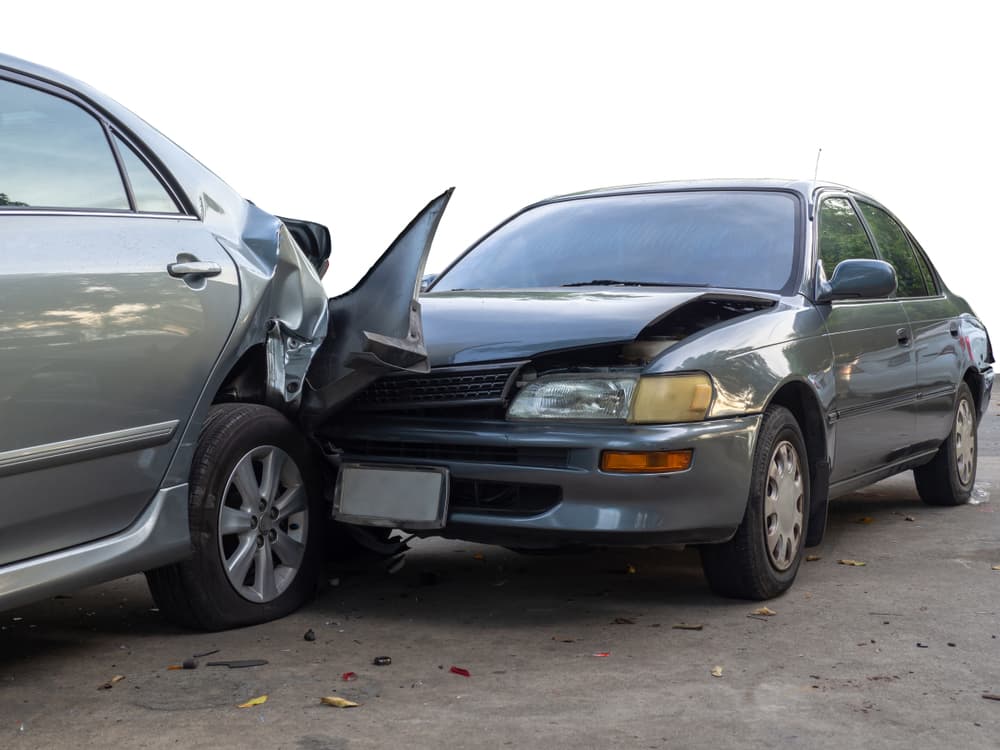 Car collision on street with wrecked and damaged vehicles, caused by negligent driving.