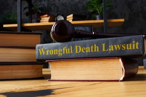 wrongful death lawsuit books stacked with gavel